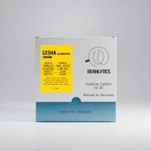 Front view of Beanlytics Roasters Gesha Colombia specialty coffee box, featuring a white and teal package with a yellow origin label that lists producer, elevation, variety, process, and tasting notes.