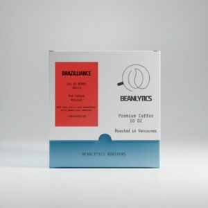 Front view of a Beanlytics Roasters coffee box featuring the “Brazilliance” Brazil Sul de Minas Red Catuai Natural coffee. The white box has a red label on the left with tasting notes and a Beanlytics logo on the right, with “Premium Coffee 10 oz – Roasted in Vancouver” printed below.