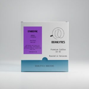Front view of a Beanlytics Roasters 10 oz coffee box featuring the “Ethiosync” Ethiopia Oromia Heirloom natural coffee. The label is deep berry purple with black text detailing tasting notes of taffy, ripe blueberry, dried cranberry, and cocoa nibs. The box base is light blue with the Beanlytics Roasters logo and “Roasted in Vancouver” printed on the front.