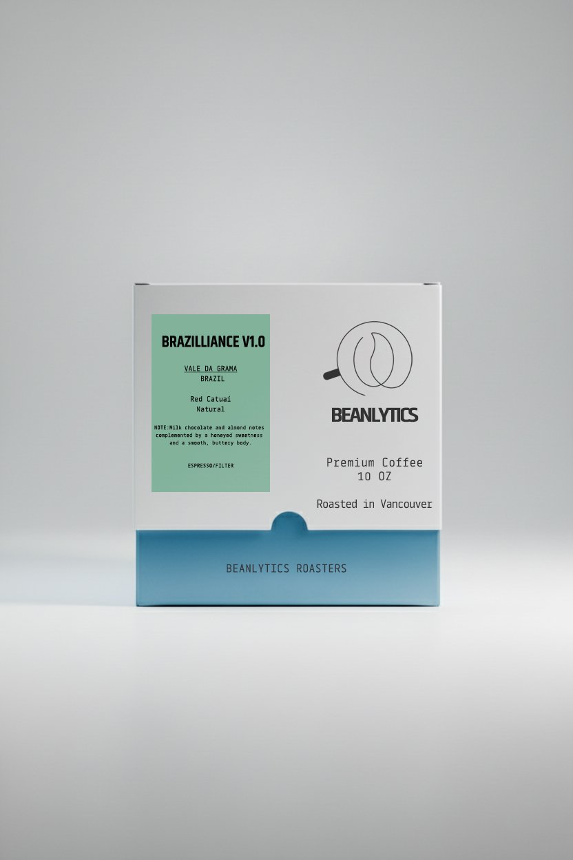 Front view of Beanlytics Roasters coffee box labeled “Brazilliance V1.0,” featuring Vale da Grama Brazil Red Catuai natural coffee. The minimalist packaging shows tasting notes of milk chocolate, almond, honeyed sweetness, and a smooth buttery body, roasted in Vancouver.