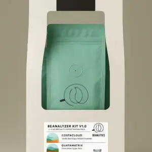 A product display of Beanalytics' "Beanalyzer Kit v1.0" featuring three teal coffee bags inside a clean, modern white box with a handle.